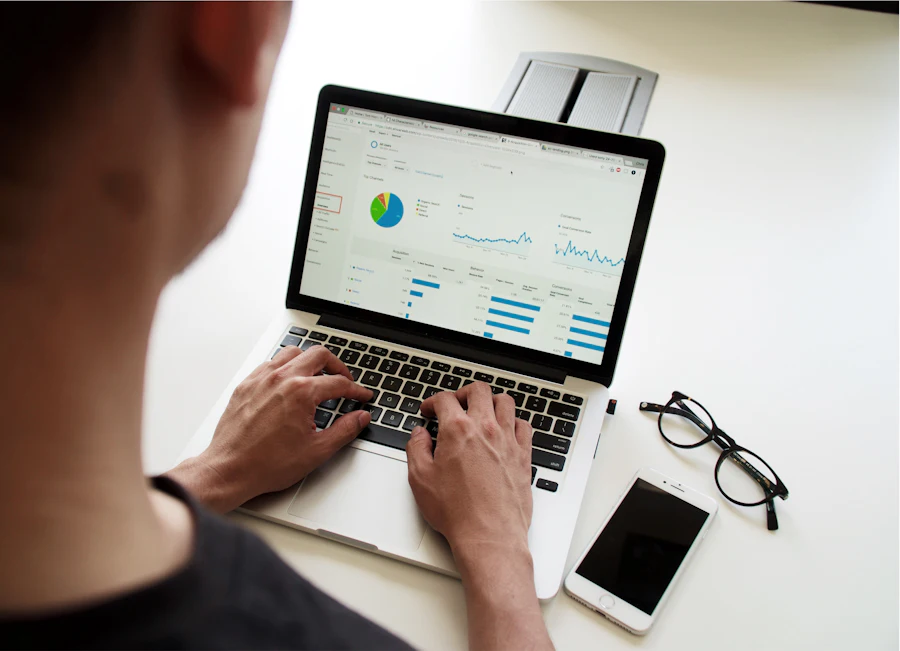 Marketing analyst reviewing campaign results on a laptop