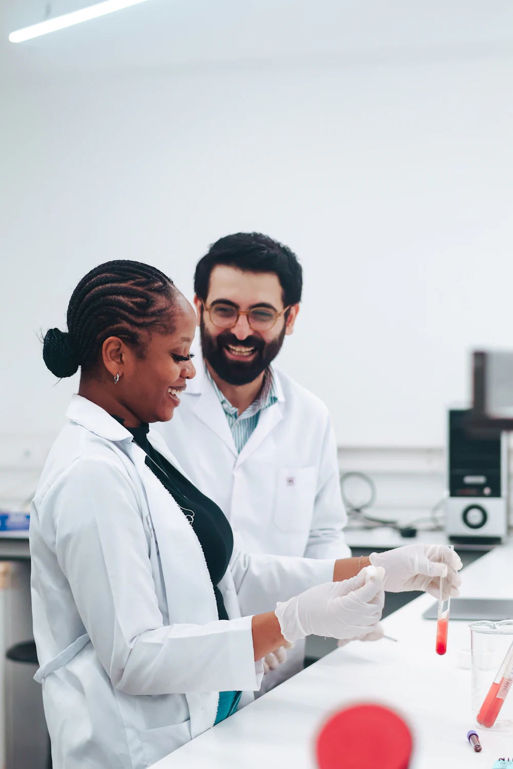 Two healthcare professionals smiling in a bright clinic
